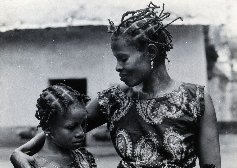 Benin: a woman and child with braided hairstyles. Photograph by H.V. Meyerowitz, 19--.