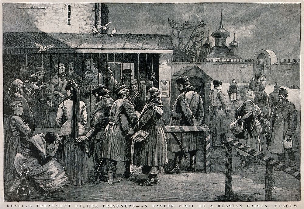 Prisoners behind bars opening on to a yard in Moscow being visited by men and women at Easter. Wood engraving, 1890.
