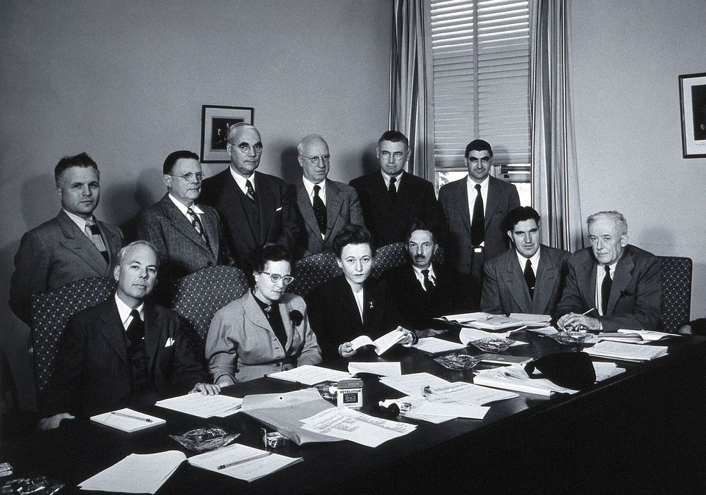 A meeting of twelve scientists on tropical medicine. Photograph.