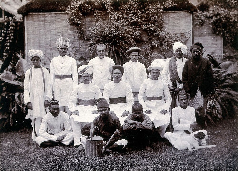 Indian men in white uniforms (domestic staff ): group portrait. Photograph, ca. 1900.