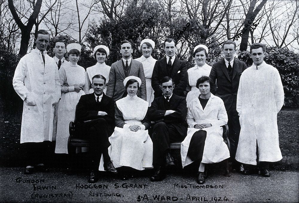 A hospital ward (acute surgical), Newcastle: nursing and medical staff group portrait, April 1924. Copy photograph after the…