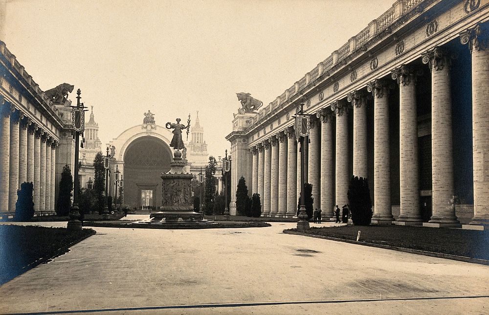 A World Fair exhibition site, United States of America: a colonnaded avenue with a central statue. Photograph, ca. 1900.