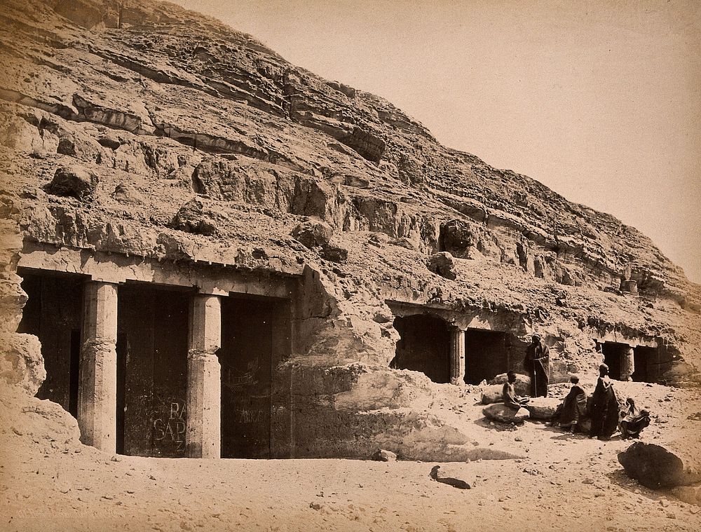 Beni Hassan, Egypt: entrance to the caves; men grouped to one side. Photograph by Pascal Sébah, ca. 1875.