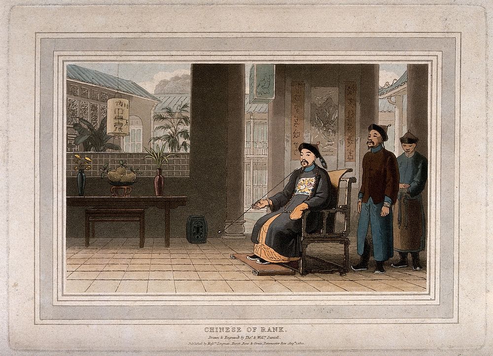 A wealthy Chinese man sits at home smoking: two servants stand nearby. Coloured aquatint by T. & W. Daniell, c. 1810.