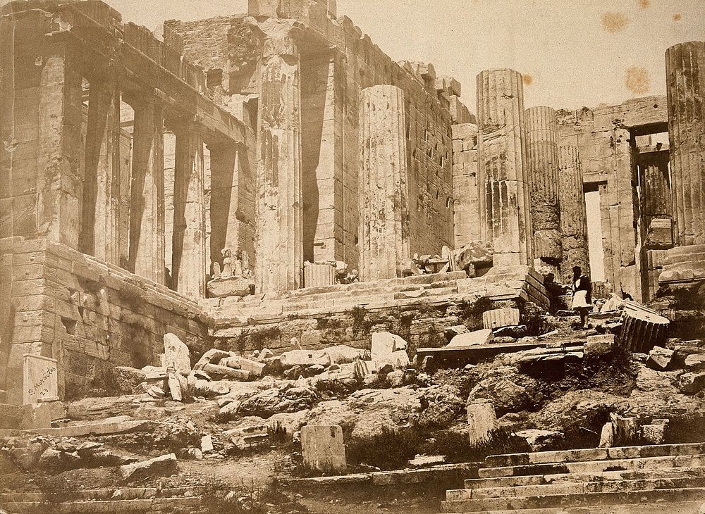 Athens: the Acropolis, showing part of the Propylea and the temple of Athena Nike, in ruins. Photograph by Petros Moraites…