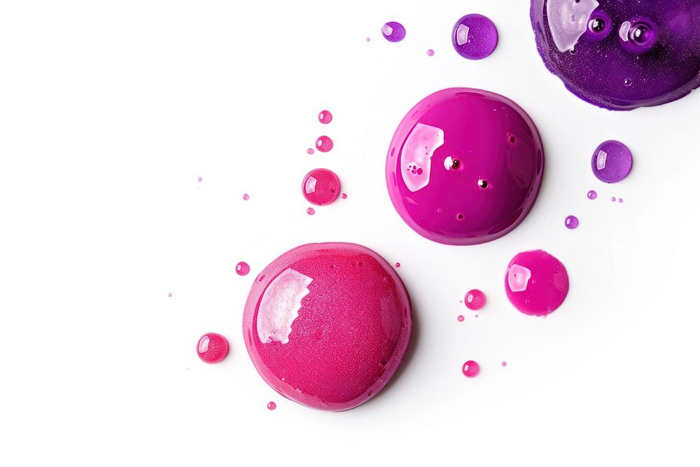 Drops of nail polish purple white background confectionery.
