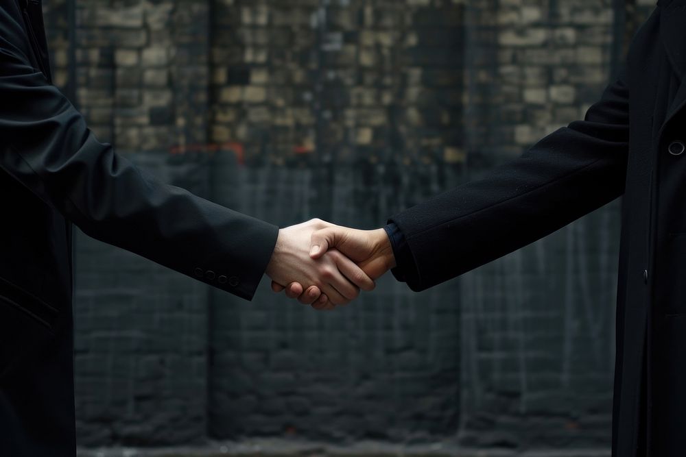 Two business men are hand shaking handshake adult architecture.