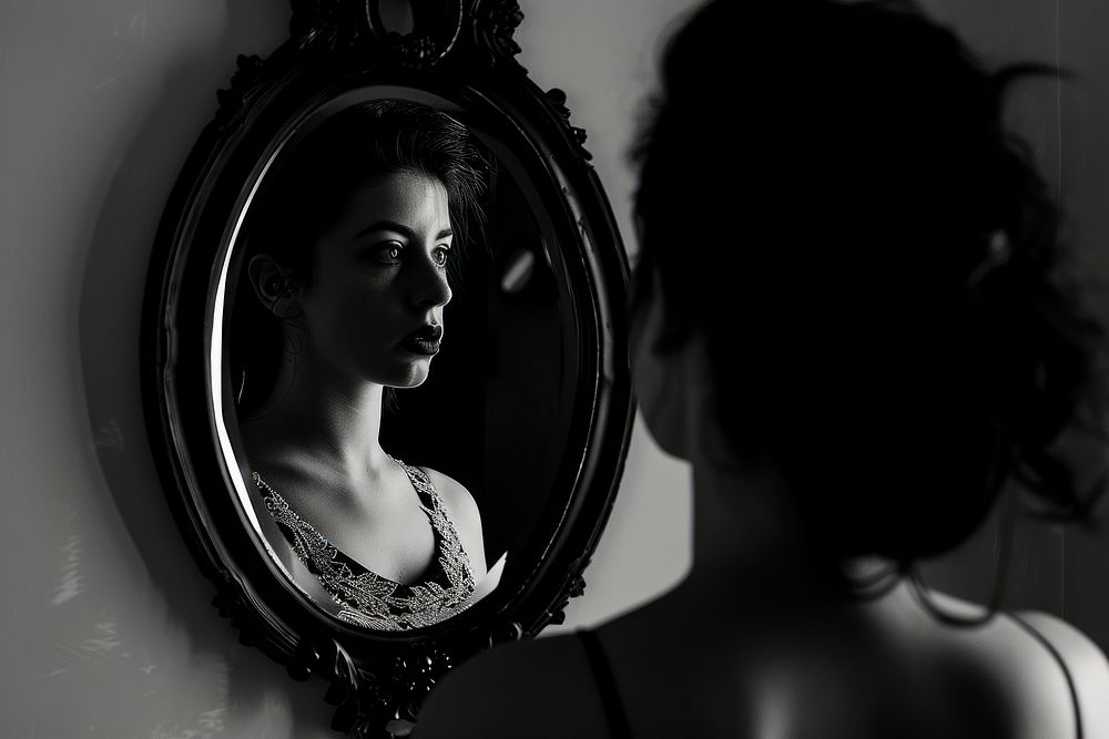 Woman looking away in the mirror portrait adult face.