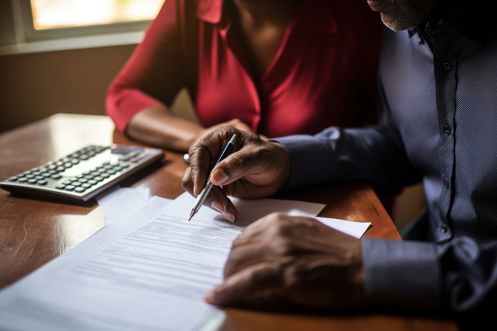 African American couple pen writing holding.