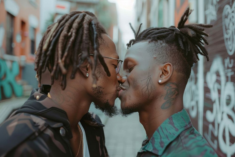 Black men kissing adult affectionate togetherness.