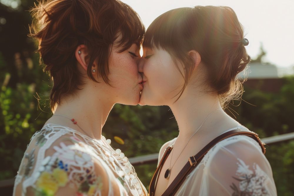 Non-binary couple kiss portrait kissing adult.
