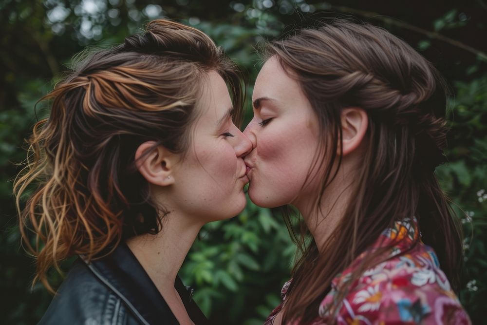 Non-binary couple kiss portrait kissing affectionate.