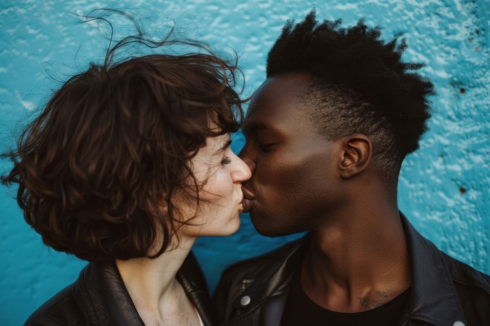 Person of color kissing portrait affectionate togetherness.