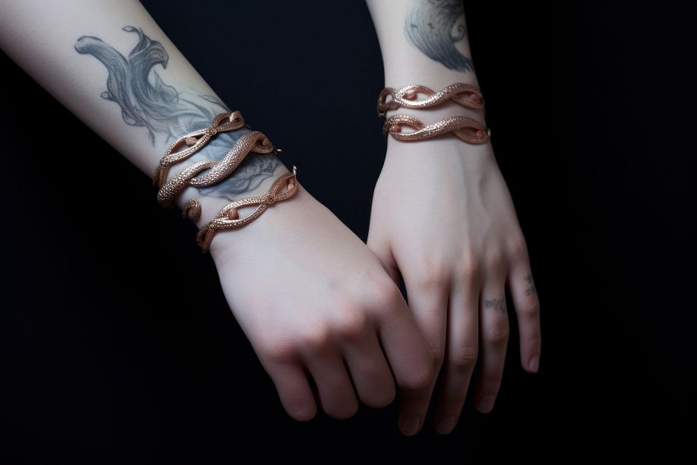 Bracelets on arms jewelry finger tattoo.