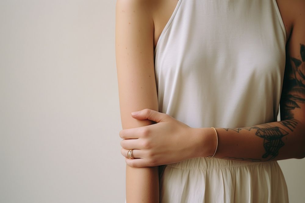 Bracelets on arms back skin midsection.