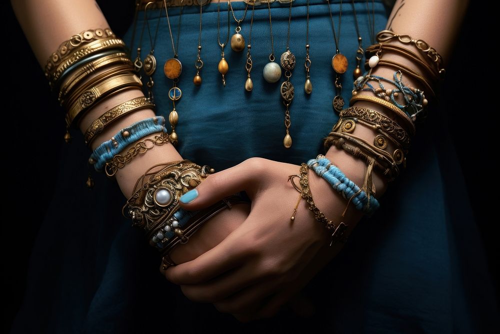 Bracelets on wrists necklace jewelry bangles.