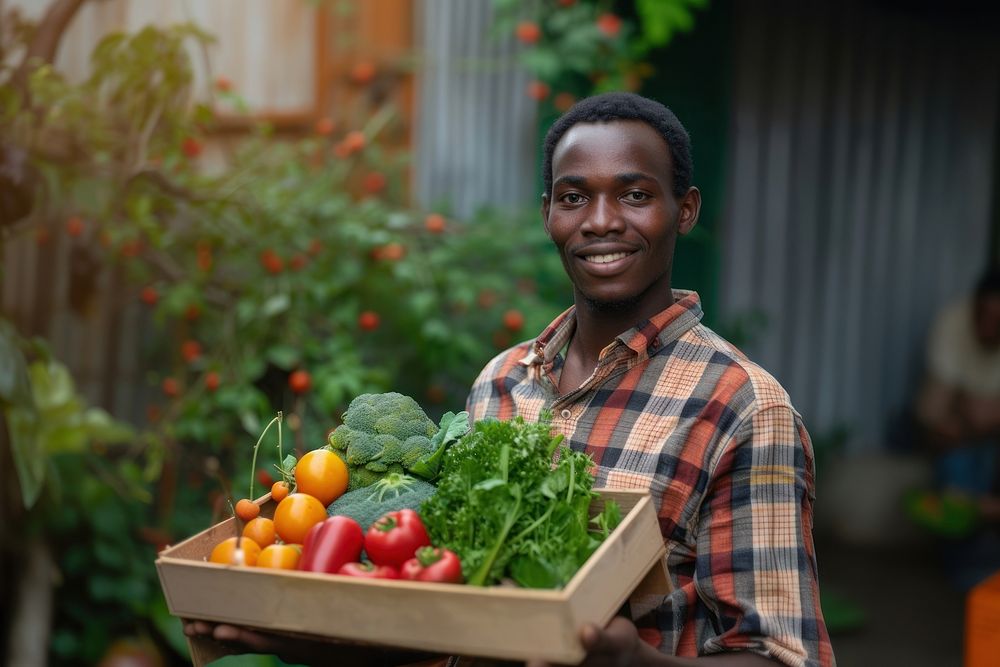 Young African Man with homemade vegetable box in hands portrait smile adult.