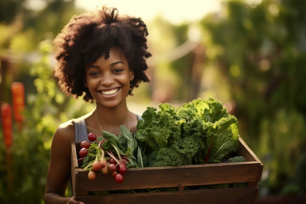 African-American women carrying a vegetable box smile garden adult.