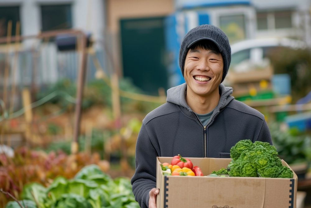 Young korean man carrying a vegetable box adult smile food.
