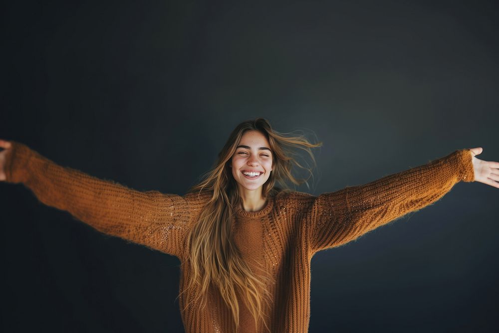 Smiling woman in weater arms outstretched portrait sweater smile.