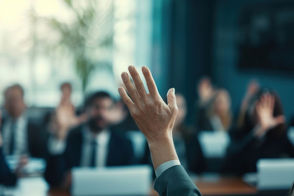 Extreme close up of business person raising hands meeting adult gesturing.