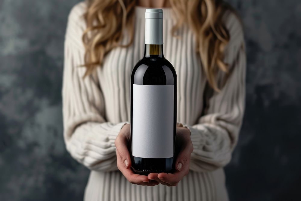 Woman holding a bottle of wine drink adult refreshment.
