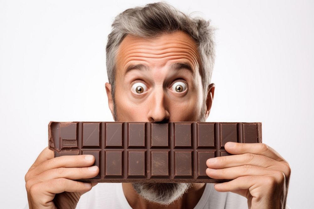 Holding chocolate with shocked face food white background surprised.