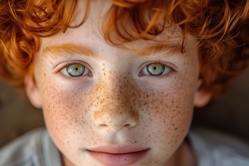 Red haired boy with freckles portrait photo skin.