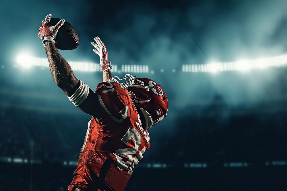 An American football player do touchdown under stadium spotlight sports helmet adult.