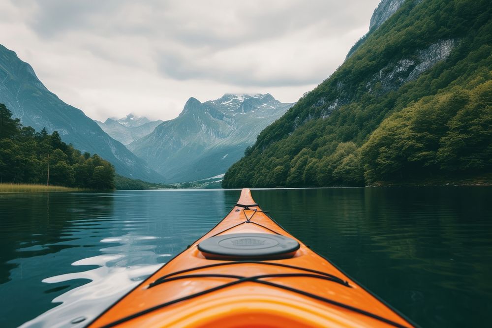 Orange canoe mountain kayaking outdoors.