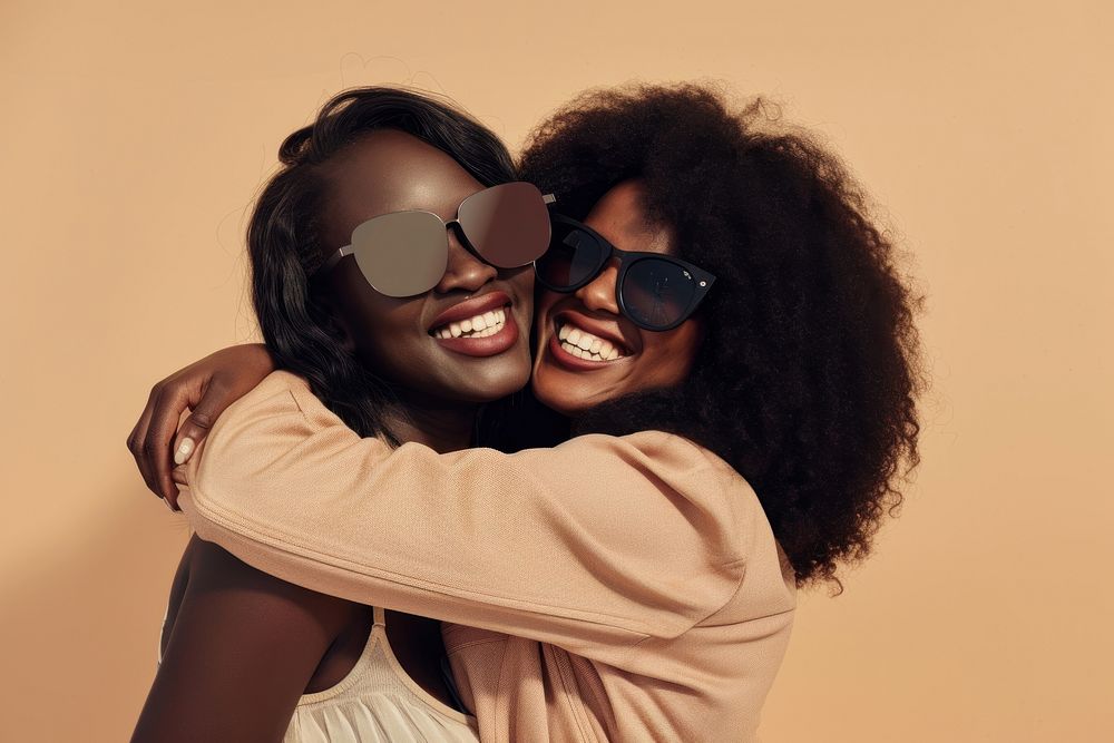 2 black woman hug sunglasses laughing portrait.