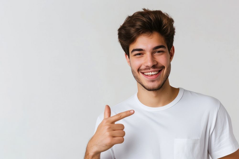 Young man t-shirt smile pointing.