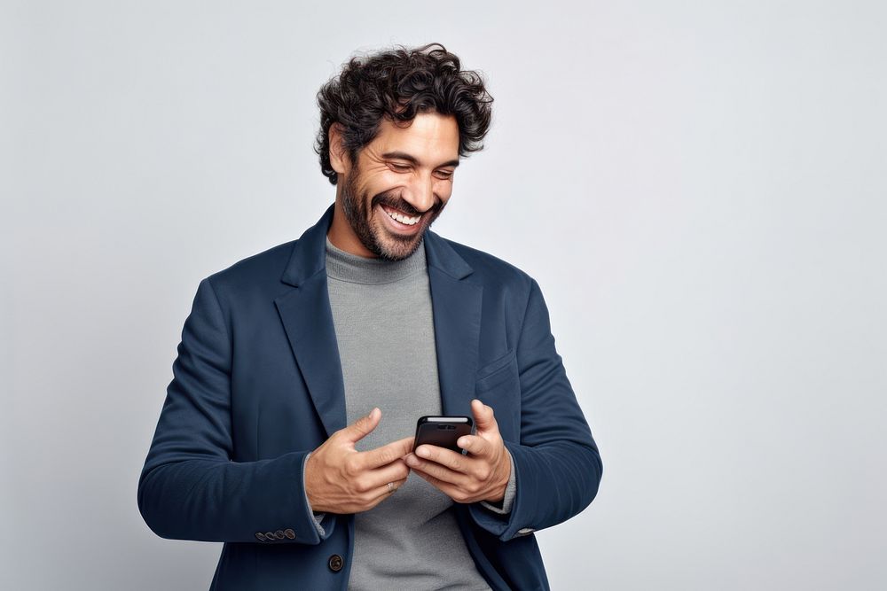 Men holding a phone smile and laugh happy laughing adult white background.