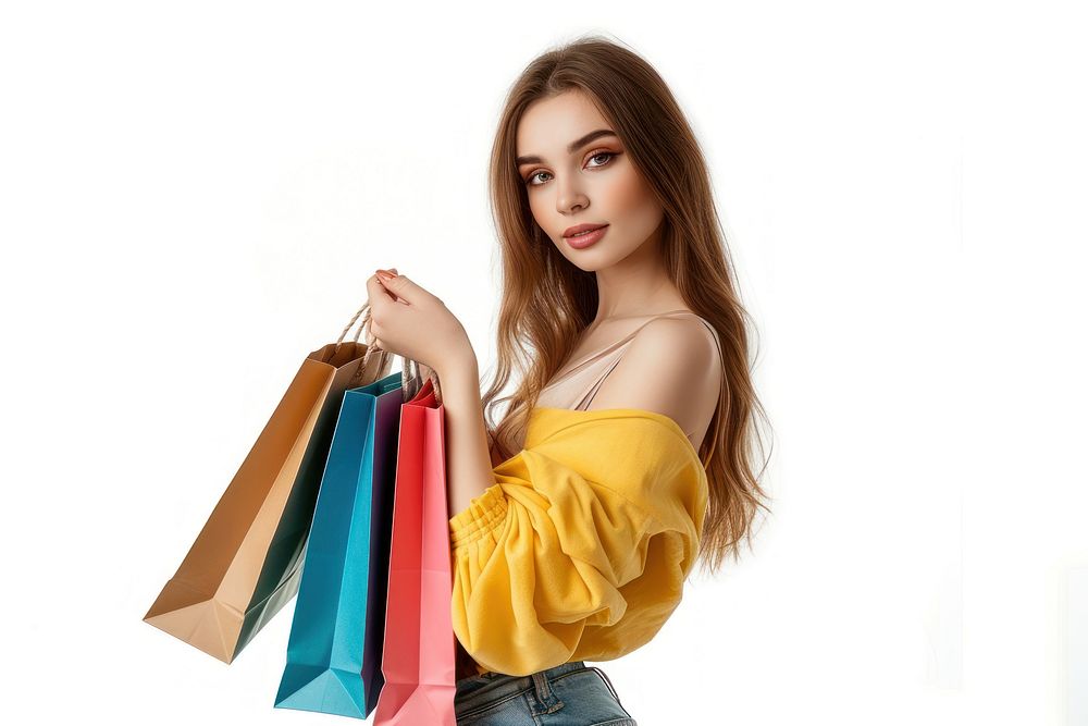 Portrait of an attractive young woman posing and holding up shopping bags portrait white background consumerism.