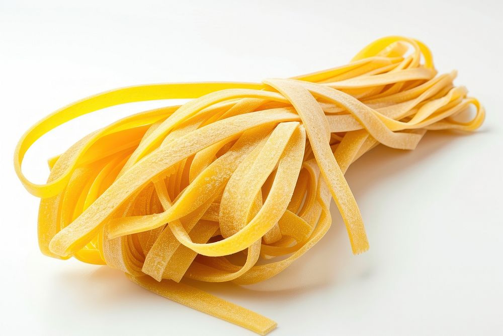 Raw fettuccine pasta from durum wheat food white background spaghetti.