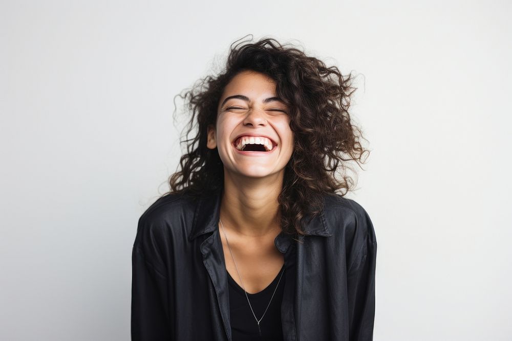 Woman holding a phone smile and laugh happy laughing adult studio shot.