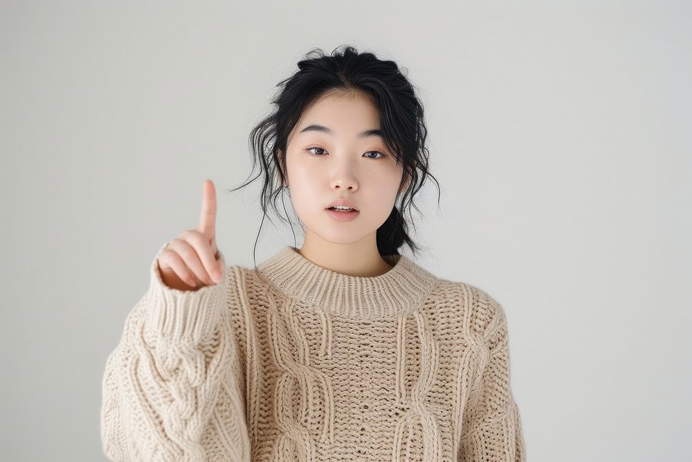 Young asian woman sweater hand white background.