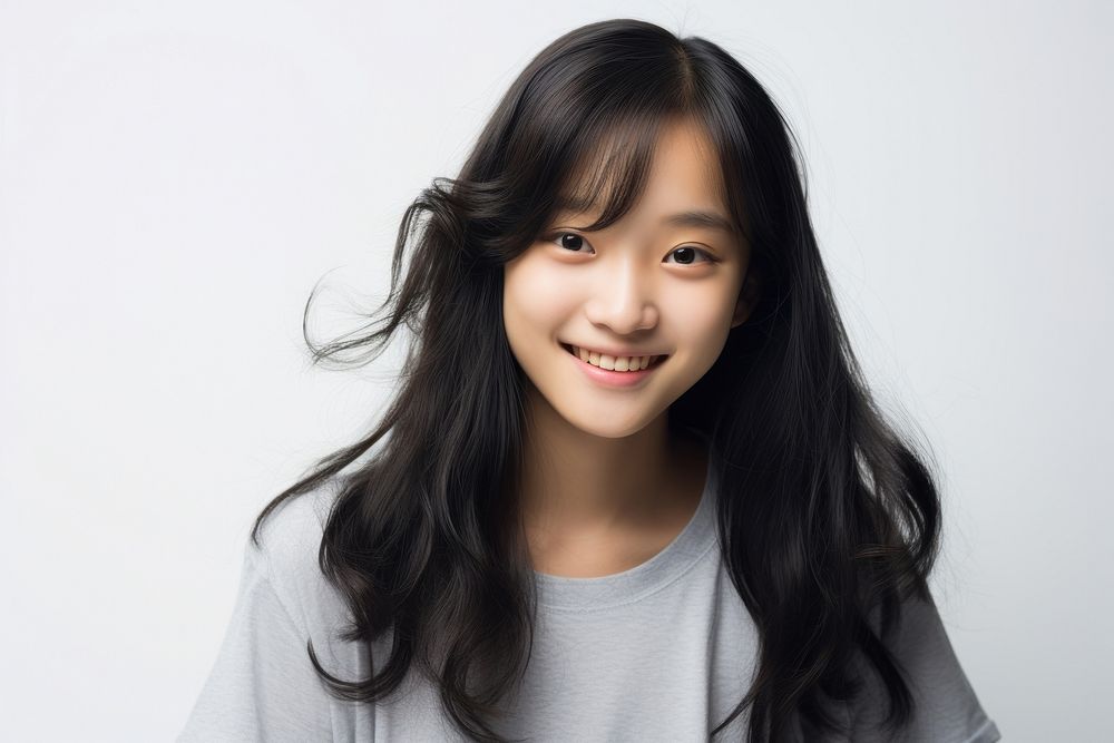 Young teenager Asian girl smiling smile white background studio shot.