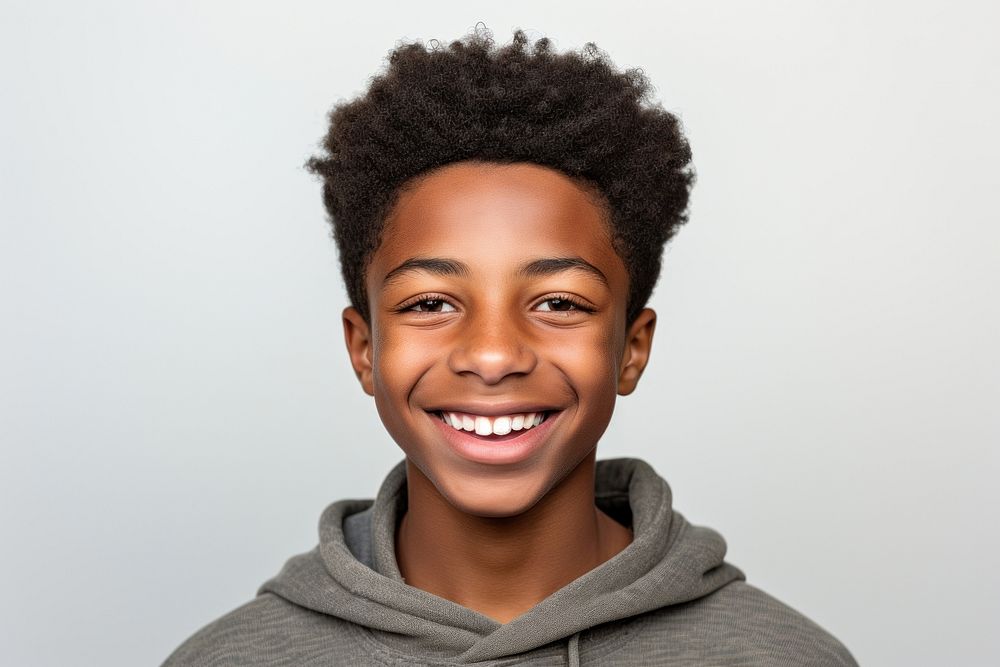 Young teenager black boy smiling portrait adult smile.