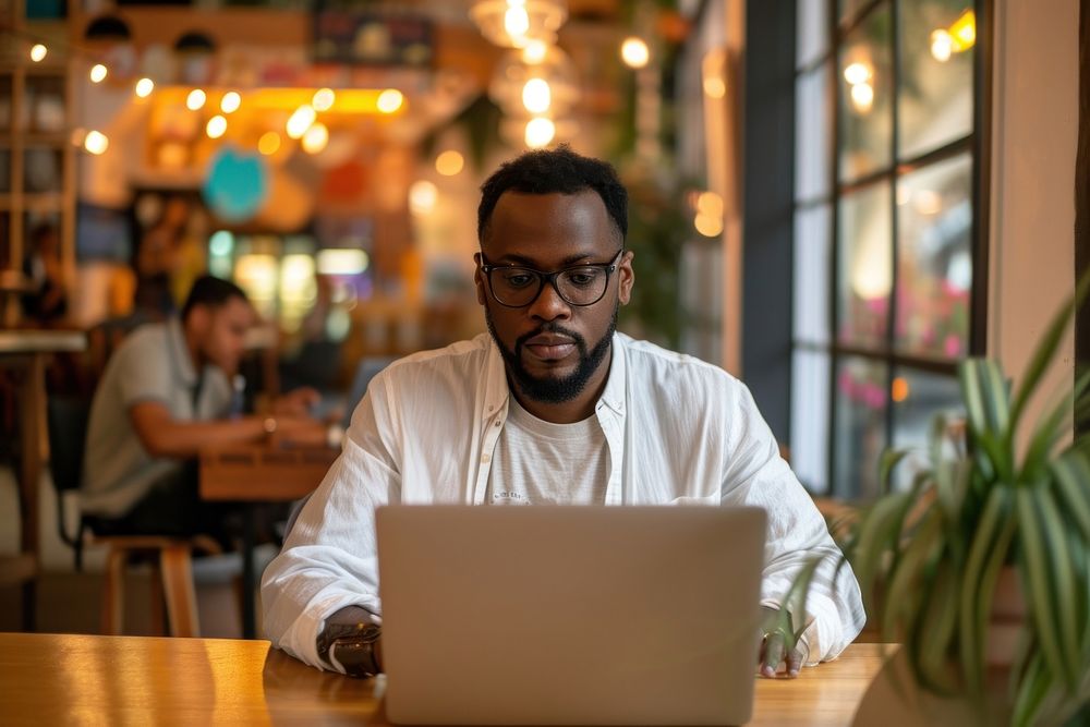 Man working on a laptop computer sitting adult.