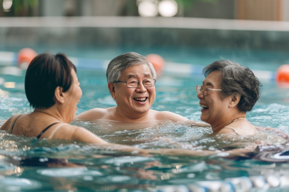 Asian Chinese Senior friends talking bonding in swimming pool bathing sports adult.