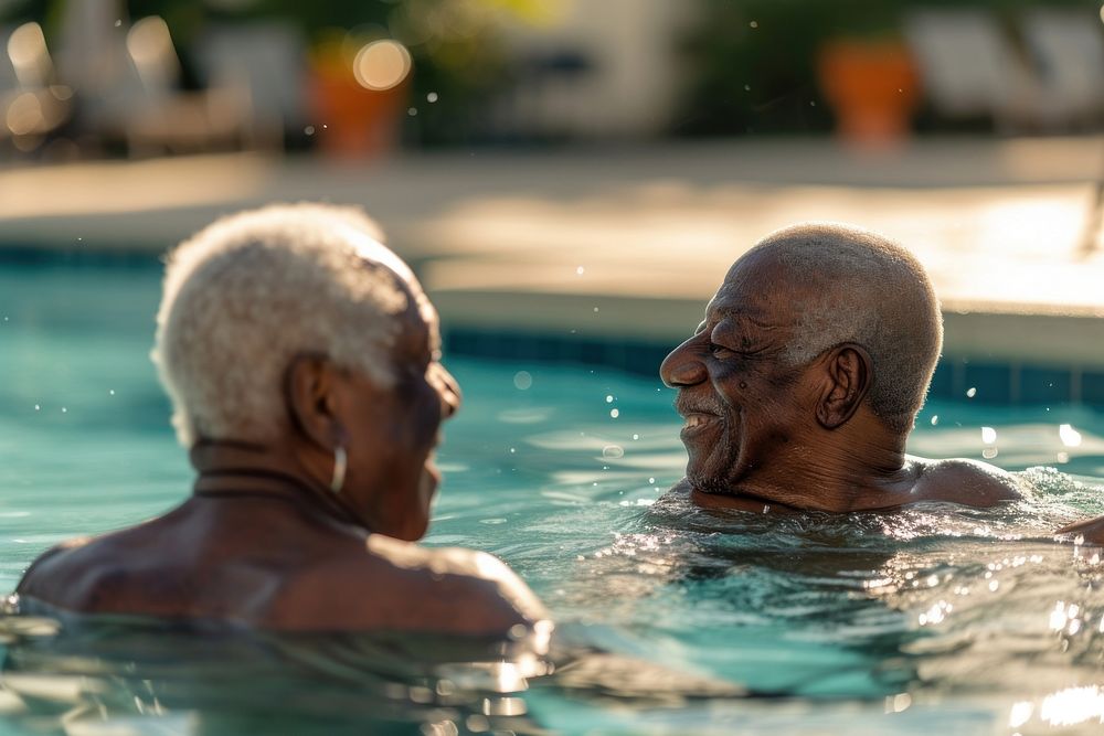 Senior friends talking bonding in swimming pool sports adult togetherness.