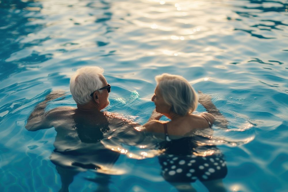 Senior friends talking bonding in swimming pool photography recreation swimwear.