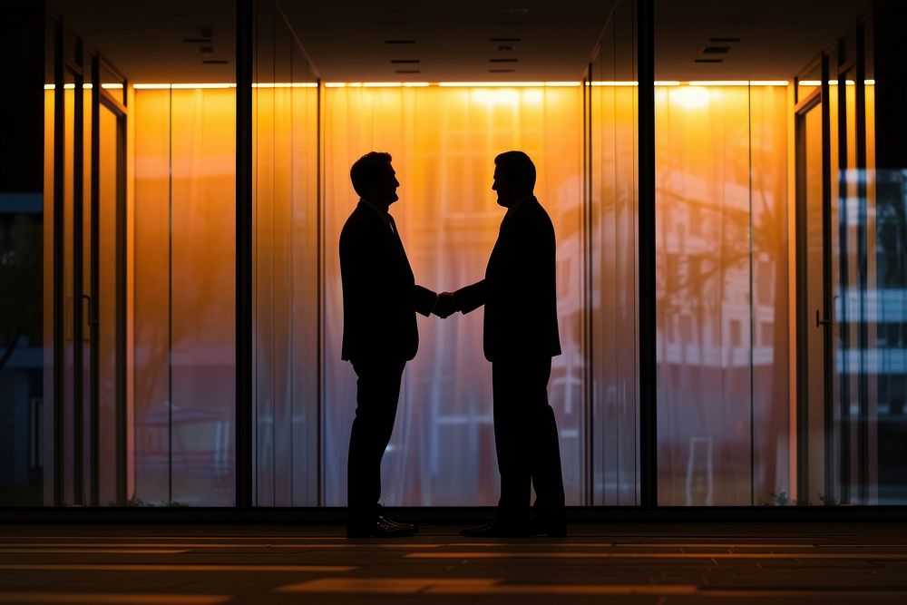 Two business men are hand shaking adult togetherness architecture.