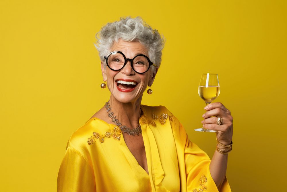Older woman wearing glasses laughing portrait yellow.