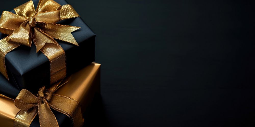 Christmas presents with gold ribbon on a black background gift celebration anniversary.