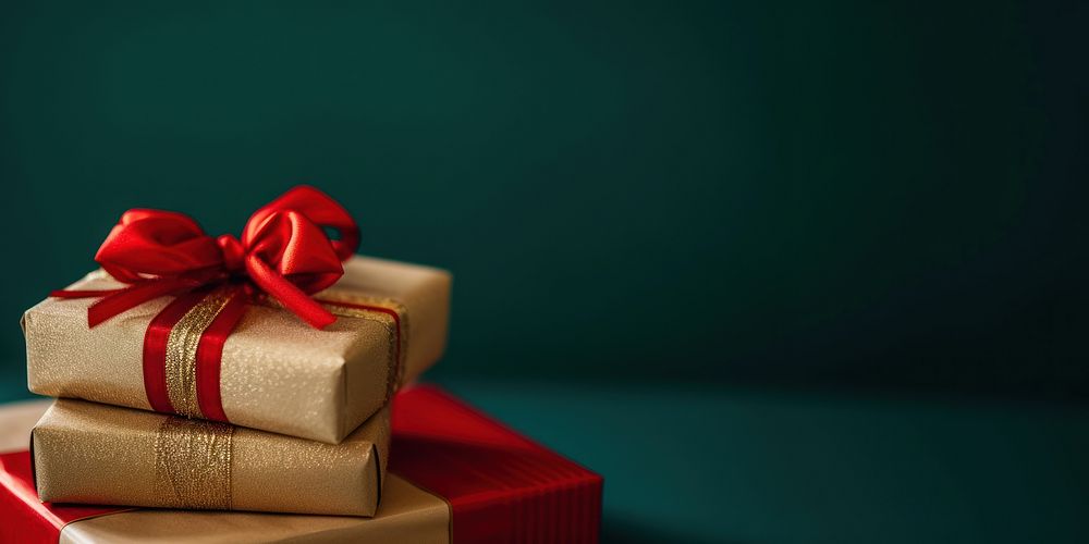Christmas presents with gold ribbon on a solid background gift celebration anniversary.