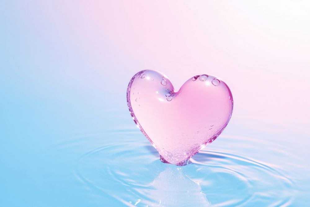 Water in heart shape pink pink background reflection.