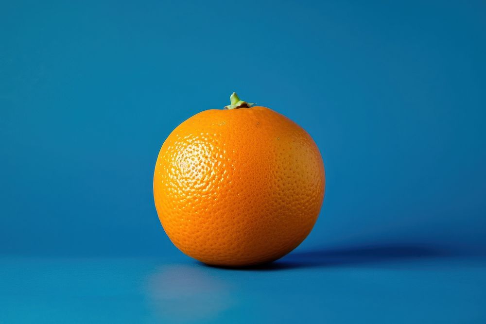 An orange on blue background grapefruit plant food.
