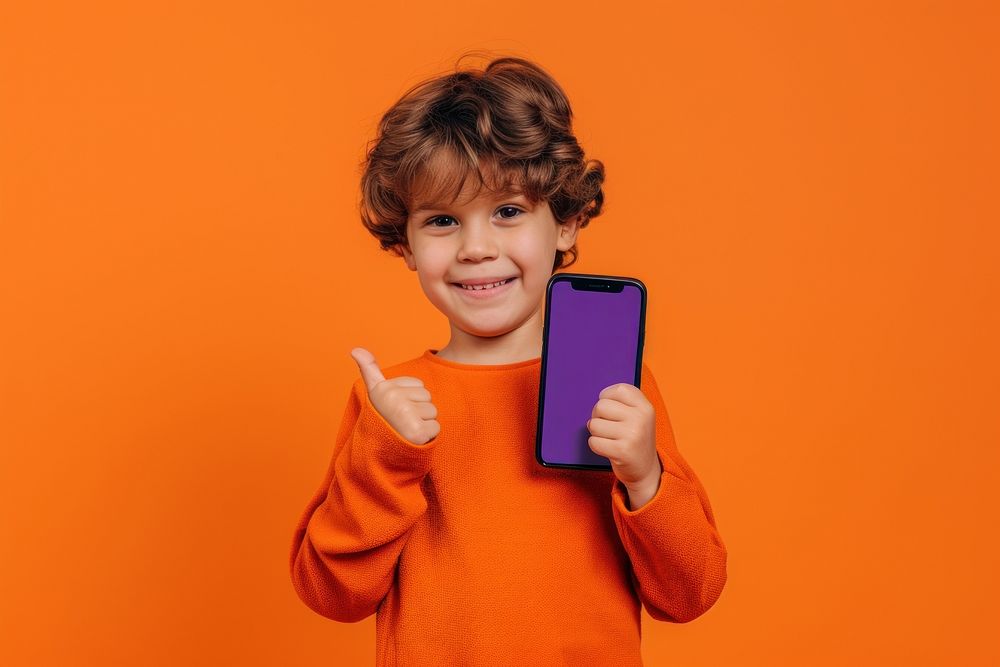 Boy showing phone screen portrait child photo.